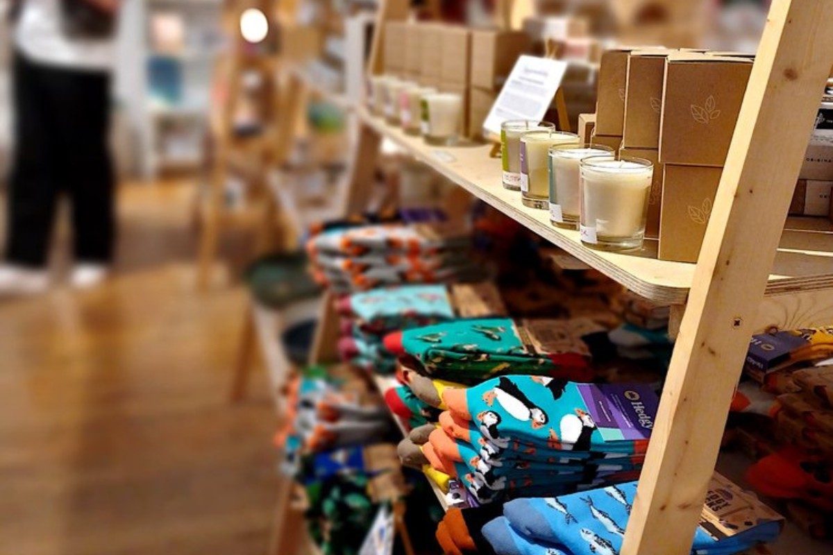 Wooden shelves with printed socks and candles